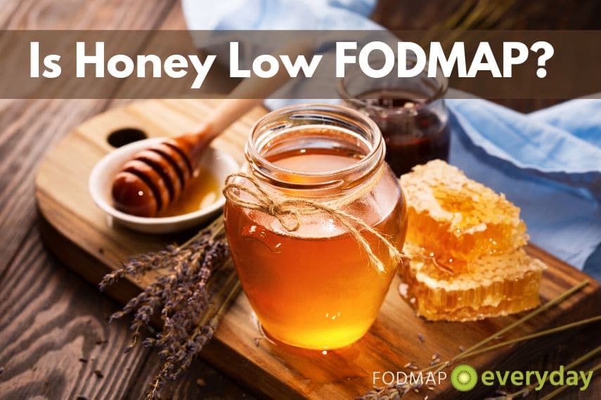 A display of different types of honey on a wooden counter.