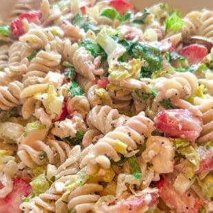 strawberry feta pasta salad in white bowl horizontal image.