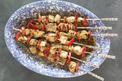 swordfish kebobs on a blue and white oval platter