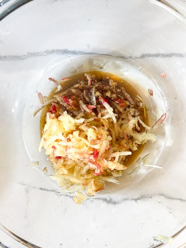 Wet ingredients for apple oat cookies in glass bowl